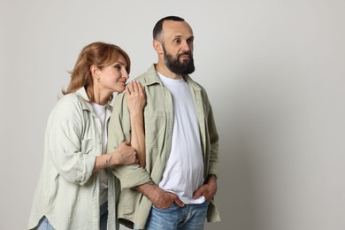 Photo of Portrait of lovely couple on light grey background, space for text