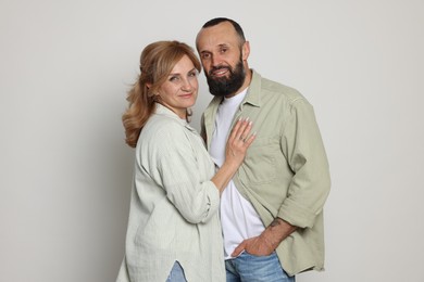Photo of Portrait of lovely couple on light grey background