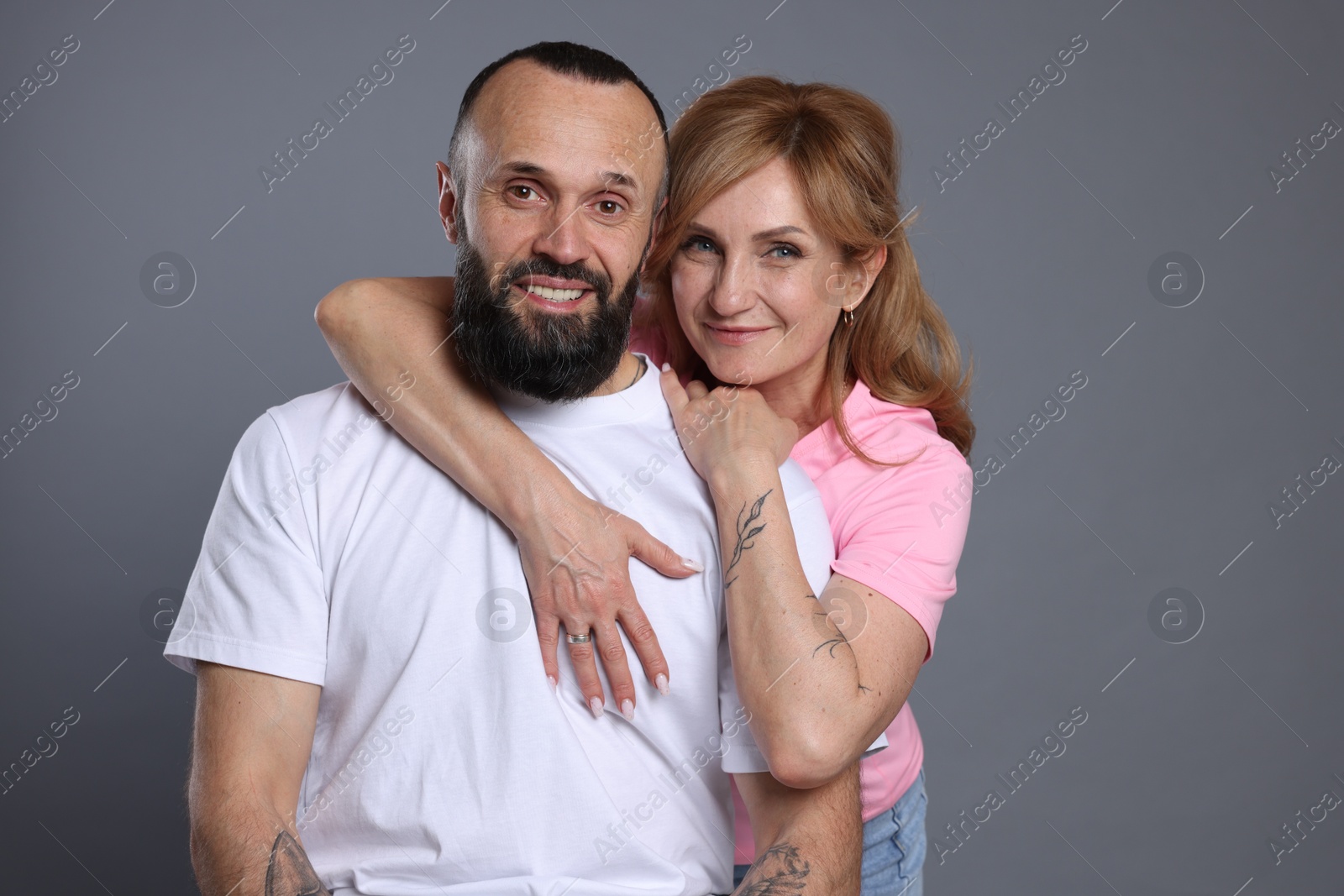 Portrait of lovely couple on grey background Photo of Portrait of lovely couple on grey background