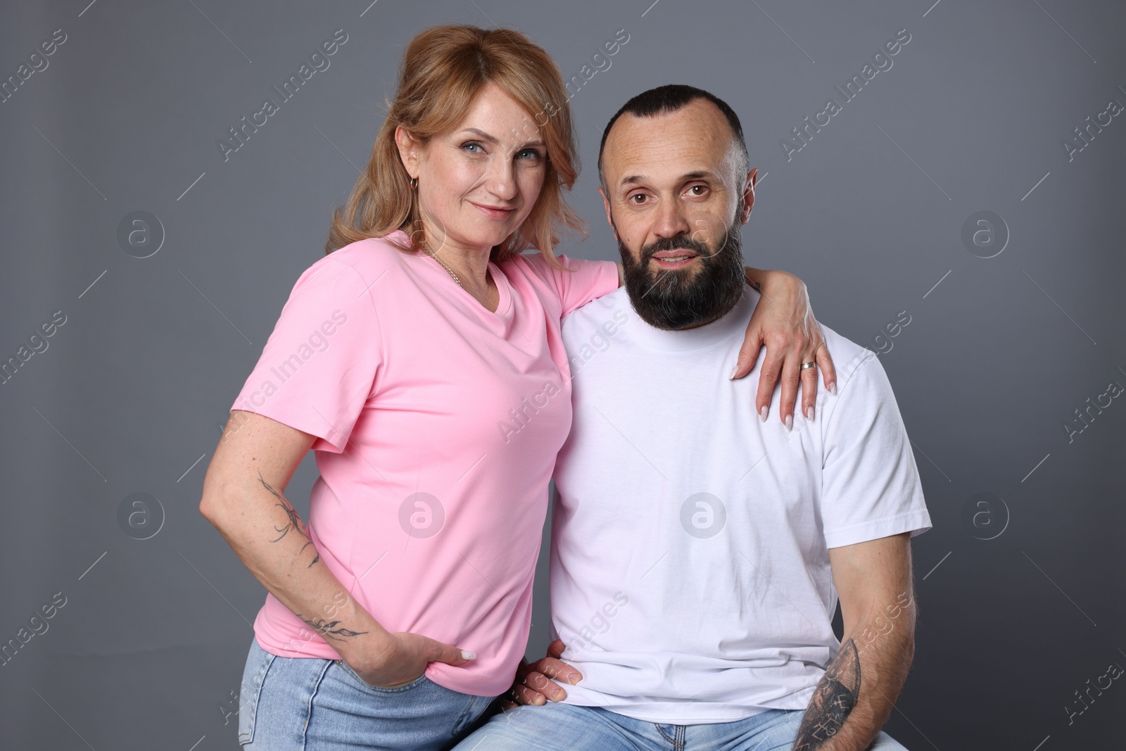 Portrait of lovely couple on grey background Photo of Portrait of lovely couple on grey background