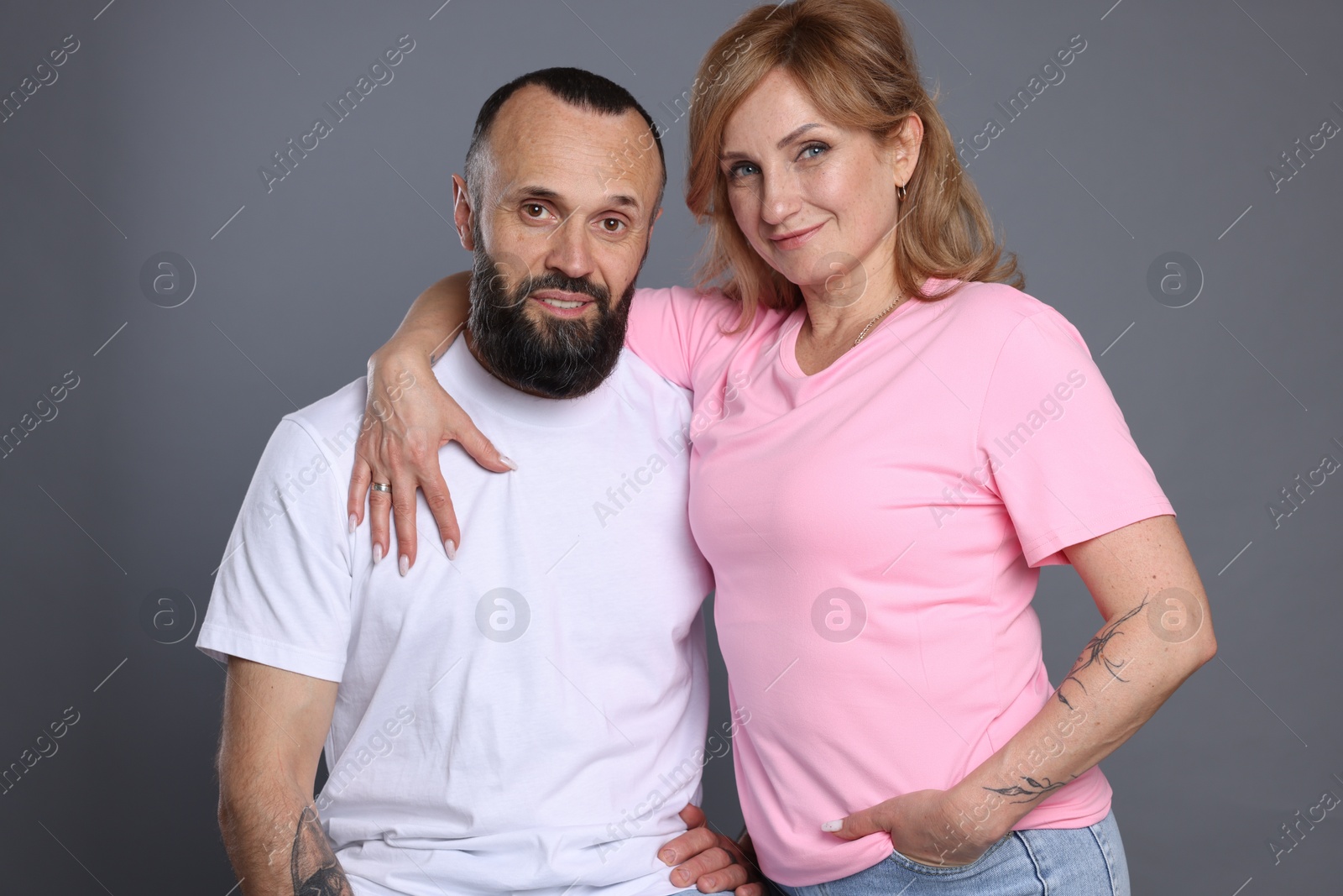 Portrait of lovely couple on grey background Photo of Portrait of lovely couple on grey background