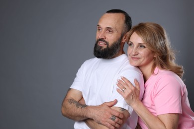 Photo of Portrait of lovely couple on grey background, space for text