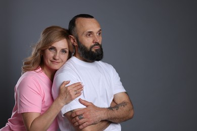 Photo of Portrait of lovely couple on grey background, space for text
