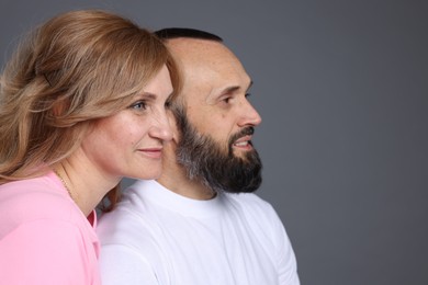 Photo of Portrait of lovely couple on grey background, space for text