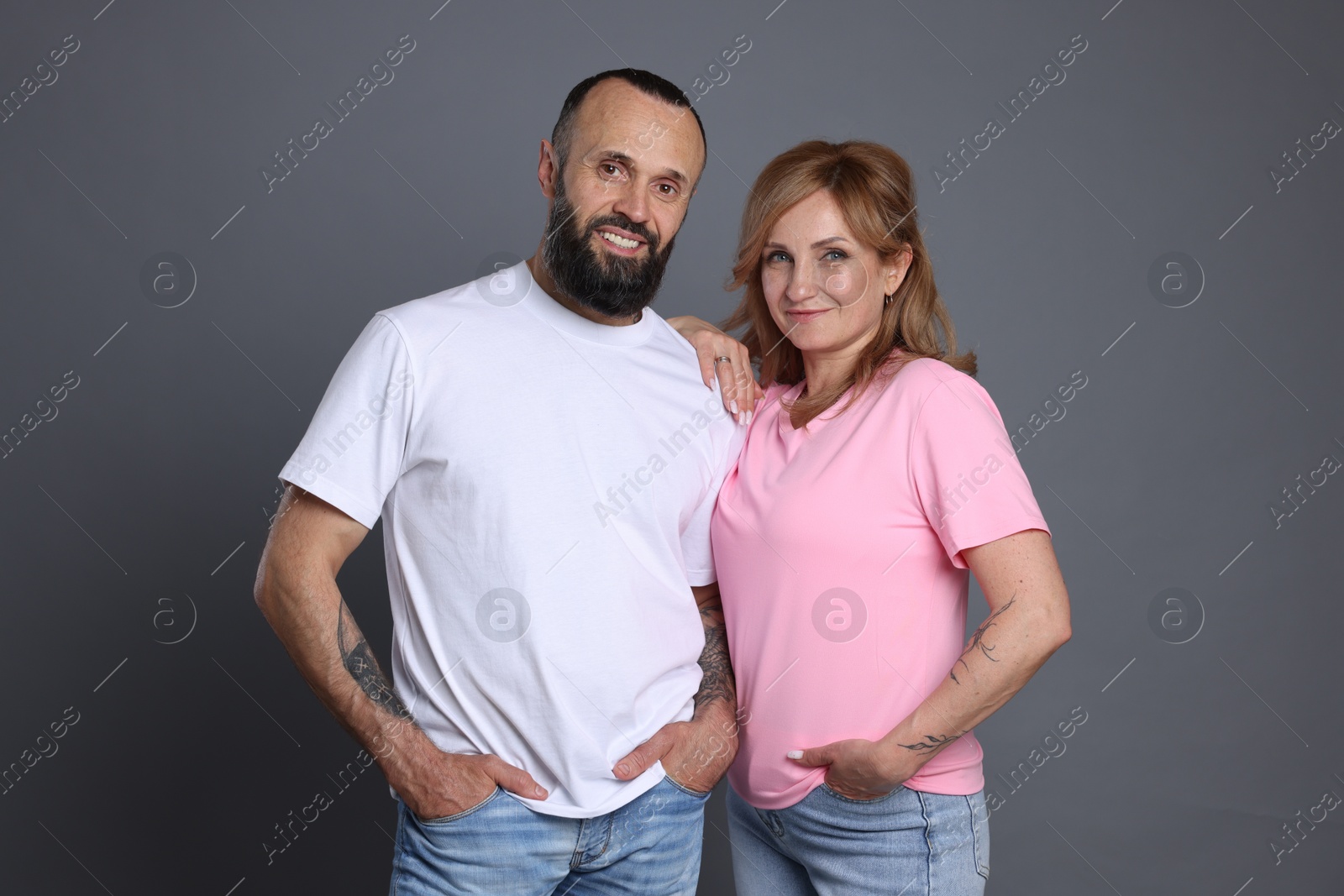 Portrait of lovely couple on grey background Photo of Portrait of lovely couple on grey background