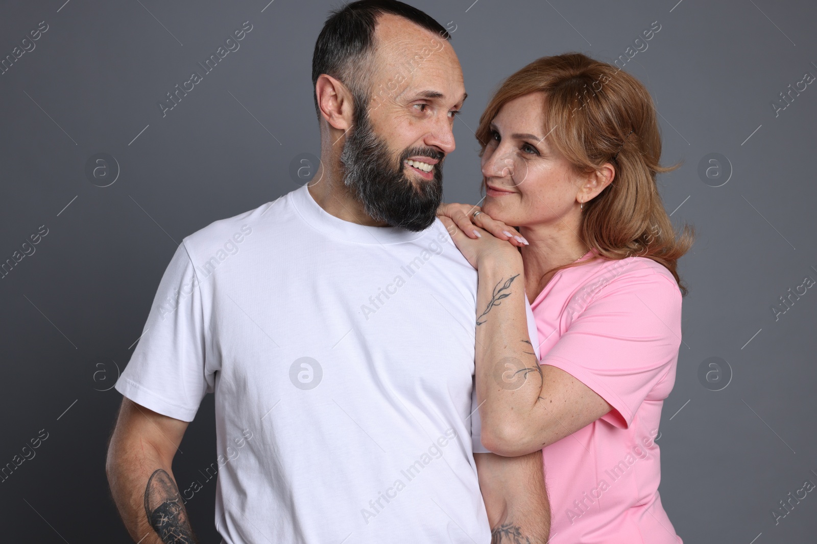 Portrait of lovely couple on grey background Photo of Portrait of lovely couple on grey background