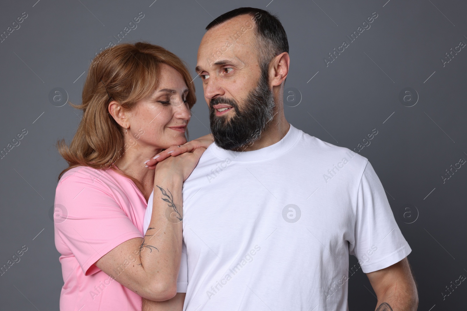 Portrait of lovely couple on grey background Photo of Portrait of lovely couple on grey background