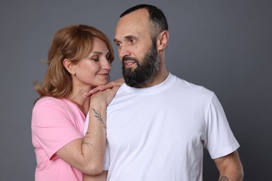 Photo of Portrait of lovely couple on grey background