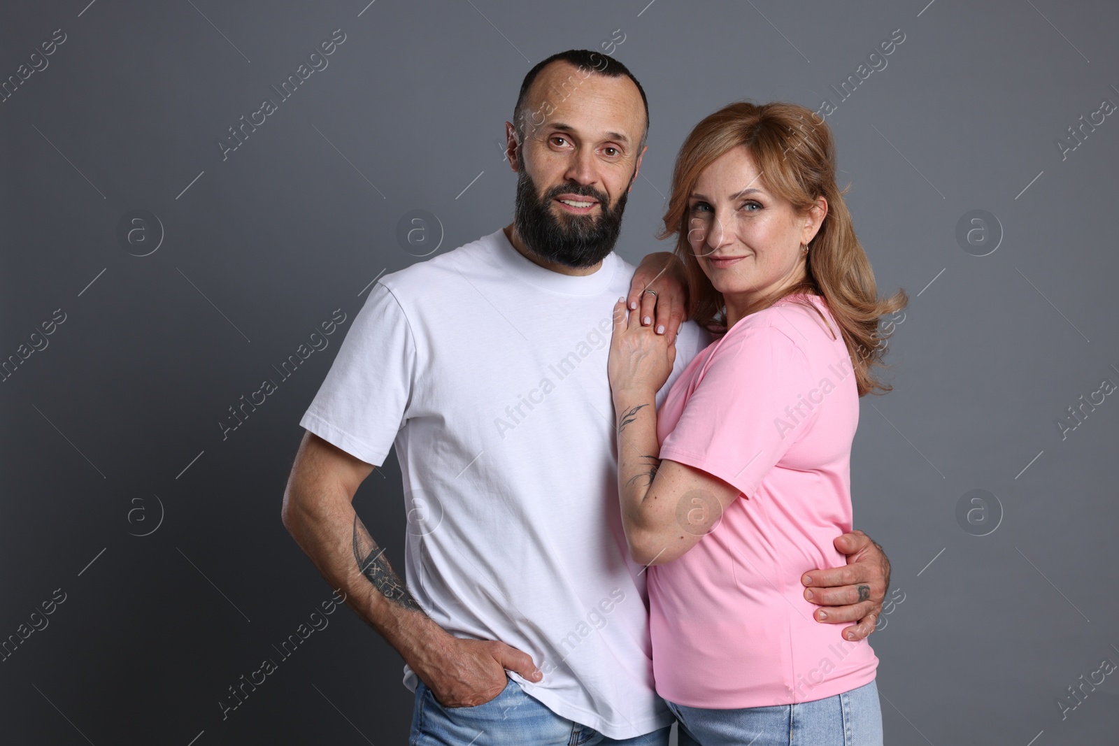 Portrait of lovely couple on grey background Photo of Portrait of lovely couple on grey background