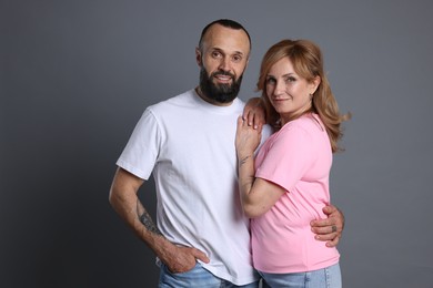 Photo of Portrait of lovely couple on grey background