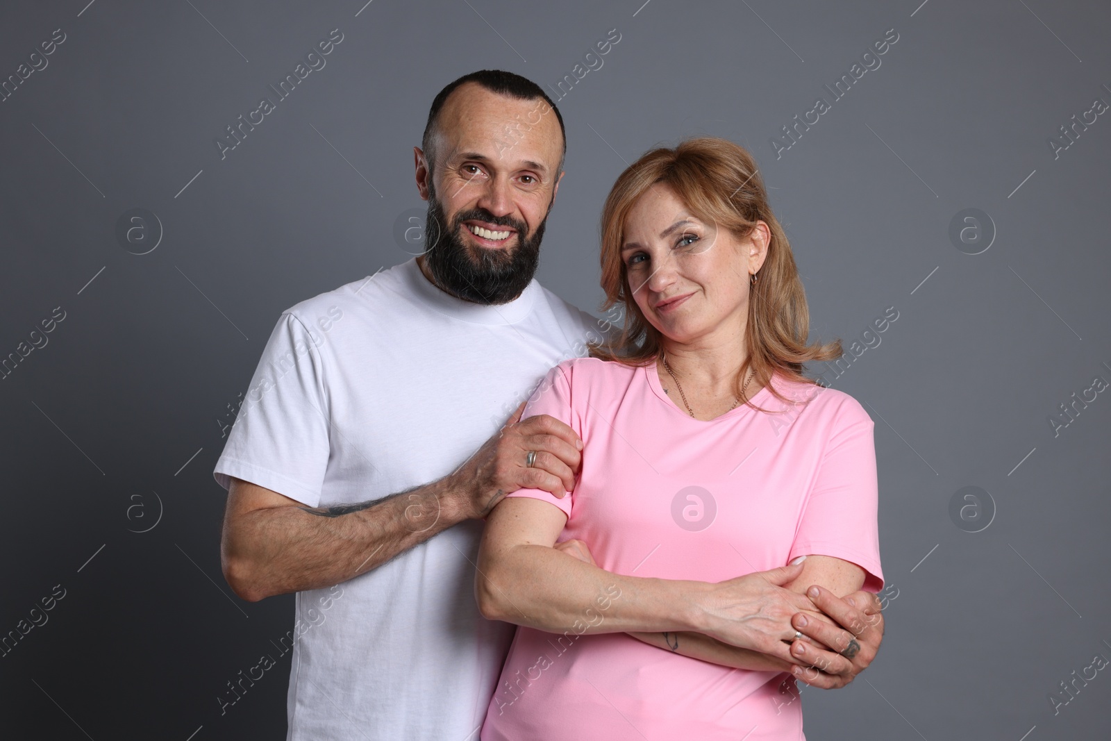 Portrait of lovely couple on grey background Photo of Portrait of lovely couple on grey background