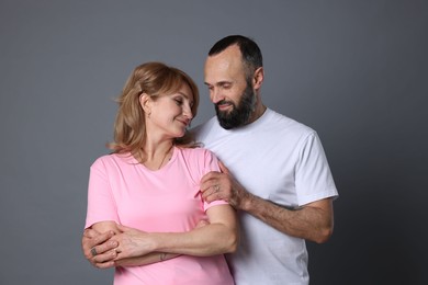 Photo of Portrait of lovely couple on grey background