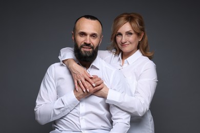 Photo of Portrait of lovely couple on grey background