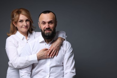 Photo of Portrait of lovely couple on grey background, space for text
