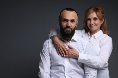 Photo of Portrait of lovely couple on grey background, space for text