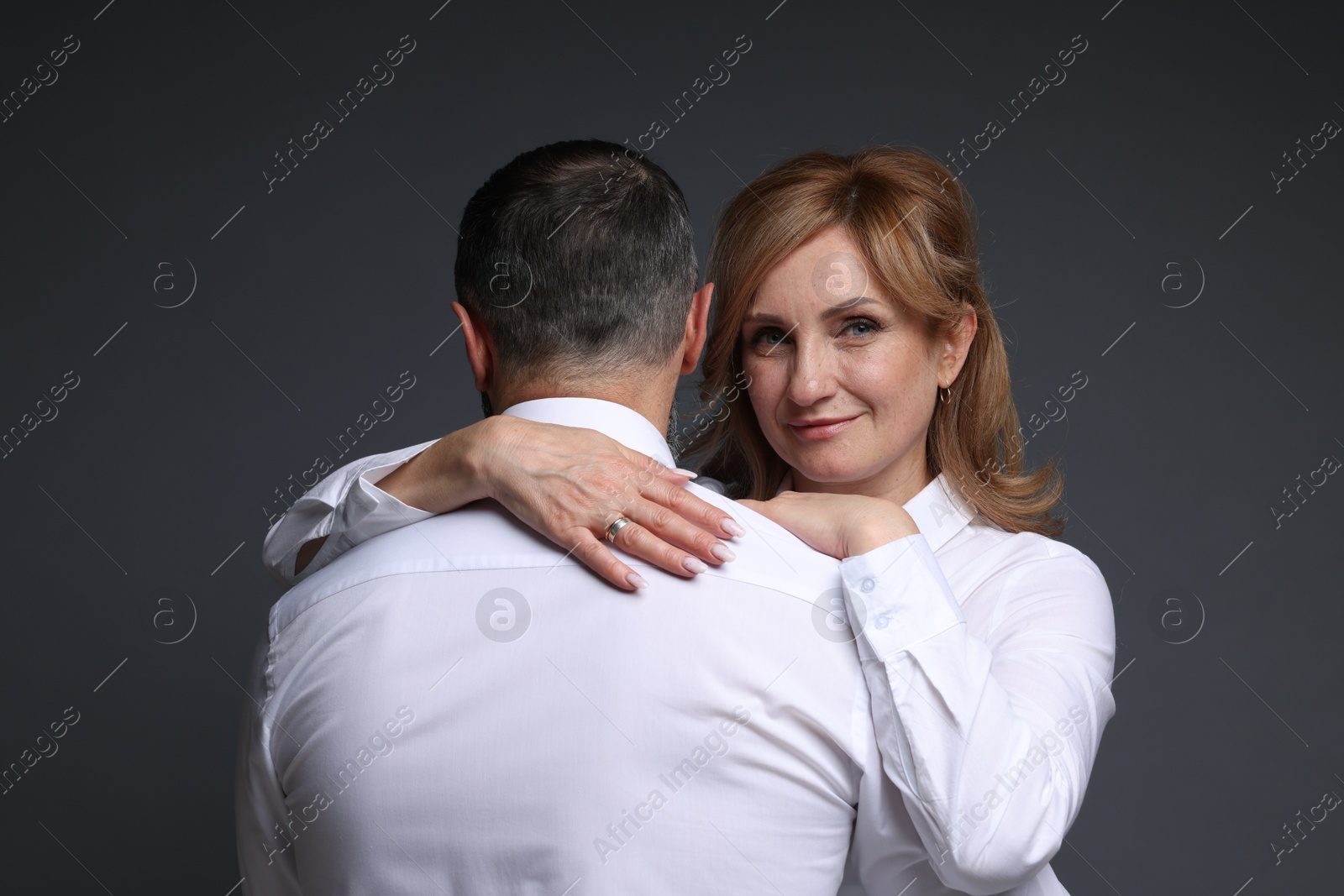 Portrait of lovely couple on grey background Photo of Portrait of lovely couple on grey background