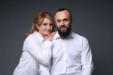 Photo of Portrait of lovely couple on grey background