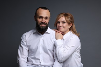 Photo of Portrait of lovely couple on grey background