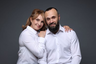 Photo of Portrait of lovely couple on grey background