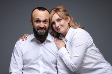 Photo of Portrait of lovely couple on grey background