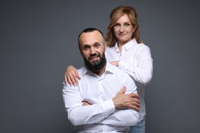 Photo of Portrait of lovely couple on grey background