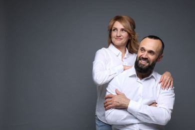 Photo of Portrait of lovely couple on grey background, space for text
