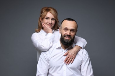 Photo of Portrait of lovely couple on grey background