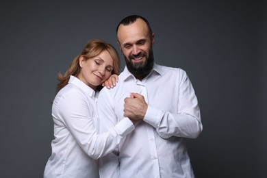 Photo of Portrait of lovely couple on grey background
