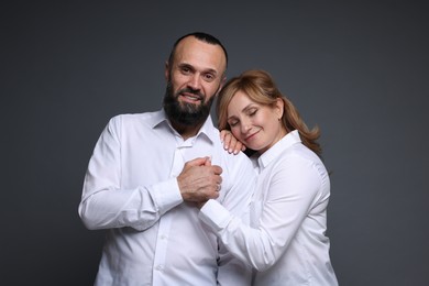 Photo of Portrait of lovely couple on grey background