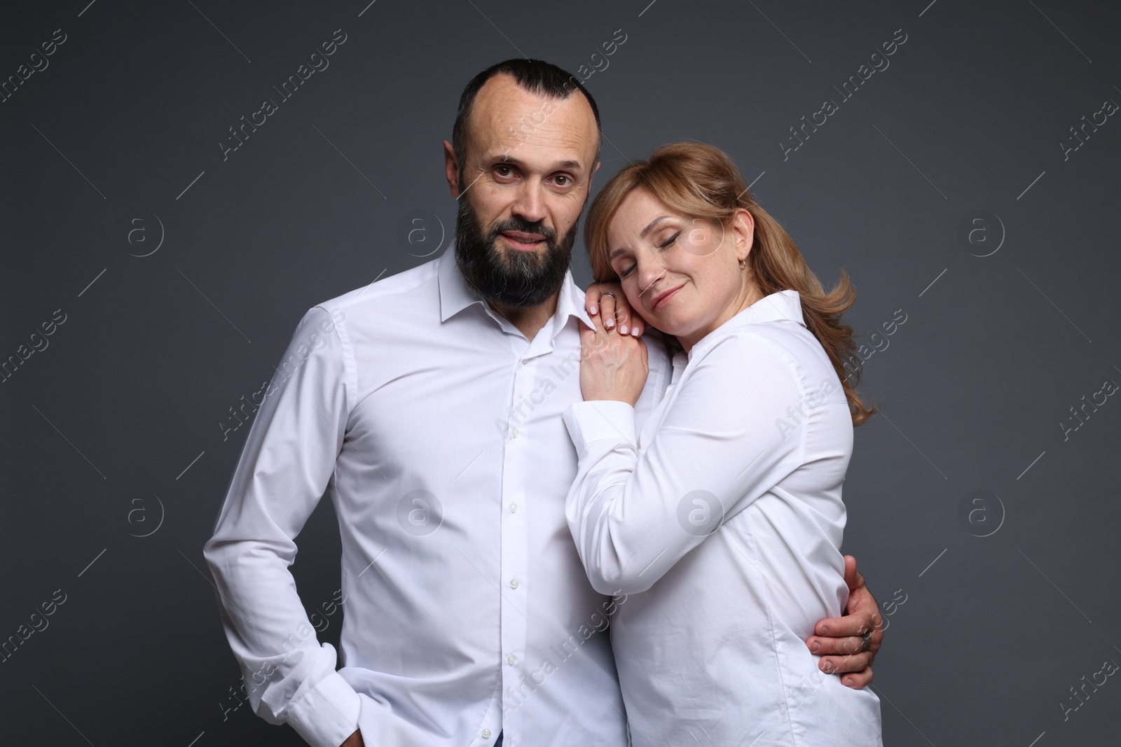 Portrait of lovely couple on grey background Photo of Portrait of lovely couple on grey background