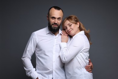Photo of Portrait of lovely couple on grey background