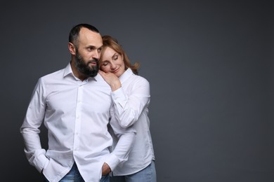 Photo of Portrait of lovely couple on grey background, space for text