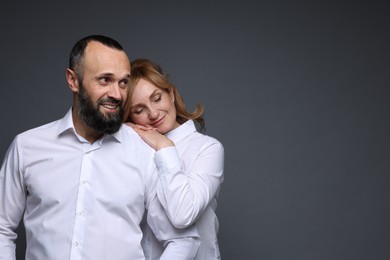 Photo of Portrait of lovely couple on grey background, space for text
