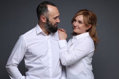 Photo of Portrait of lovely couple on grey background
