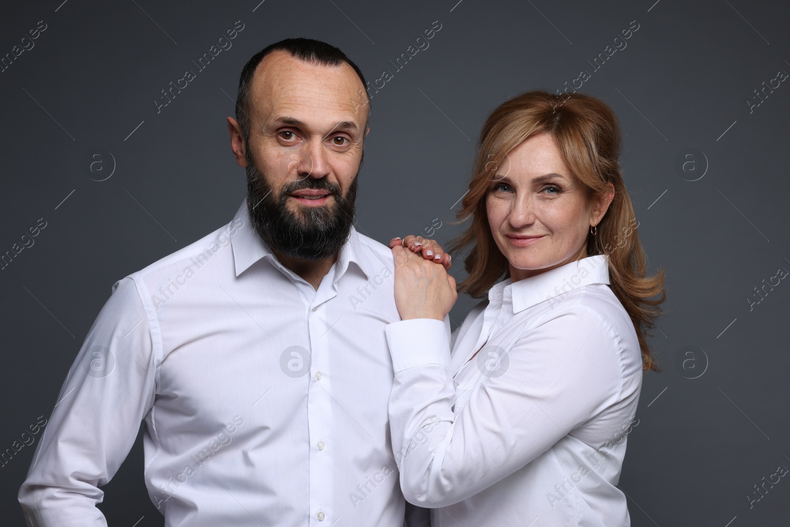 Portrait of lovely couple on grey background Photo of Portrait of lovely couple on grey background