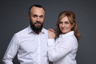 Photo of Portrait of lovely couple on grey background