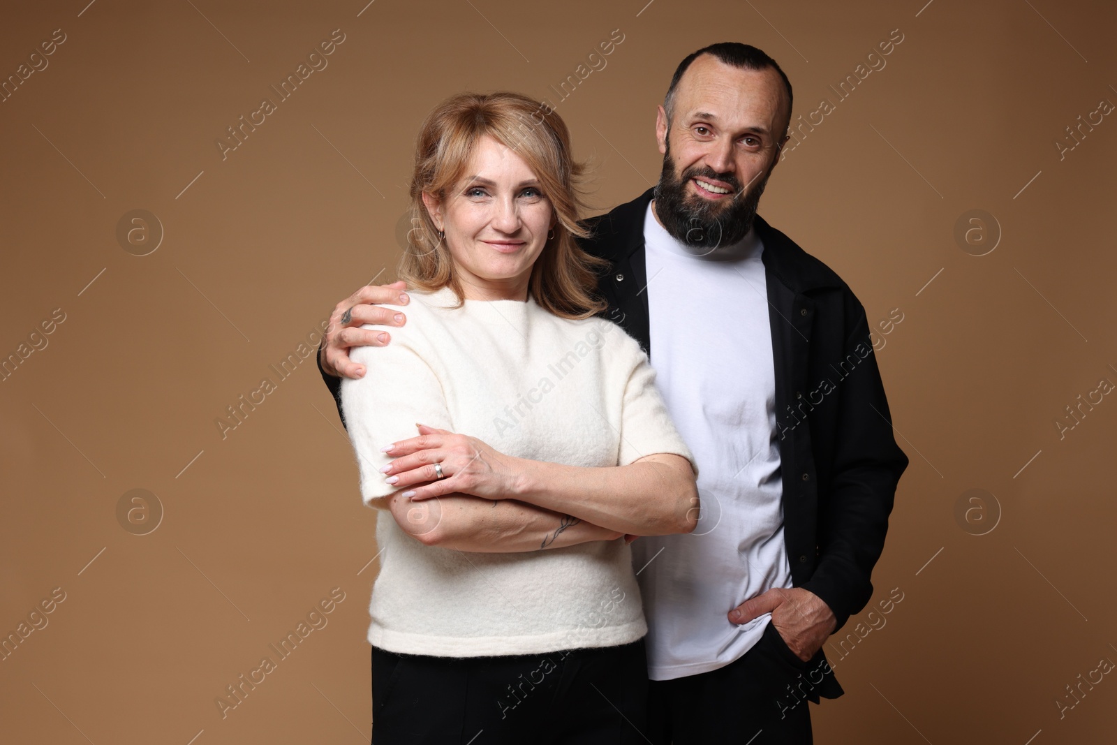 Portrait of lovely couple on brown background Photo of Portrait of lovely couple on brown background