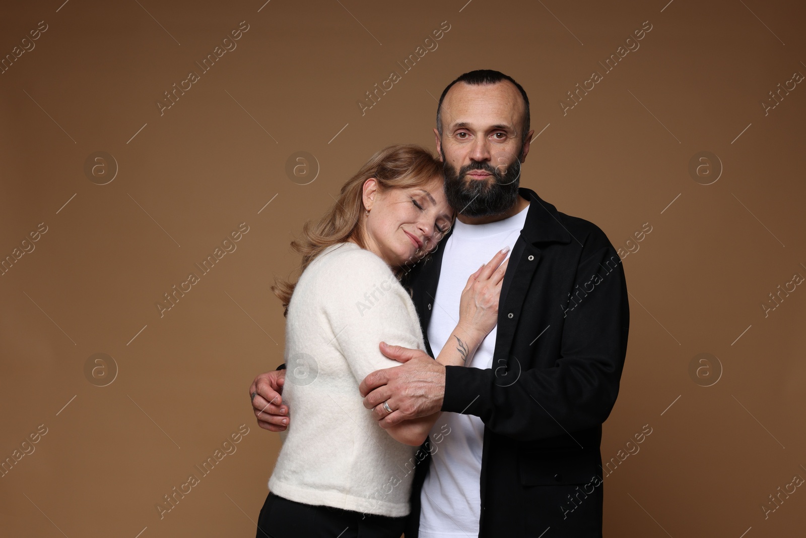 Portrait of lovely couple on brown background Photo of Portrait of lovely couple on brown background