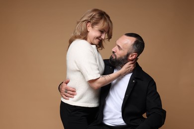 Photo of Portrait of lovely couple on brown background