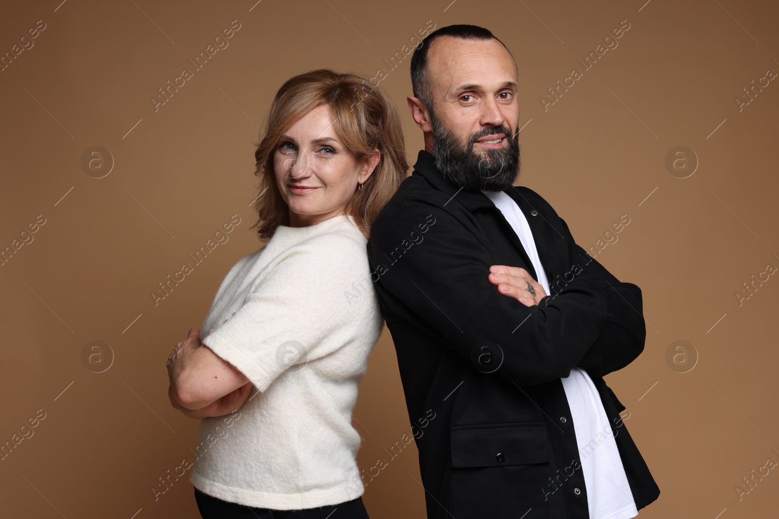 Portrait of lovely couple on brown background Photo of Portrait of lovely couple on brown background