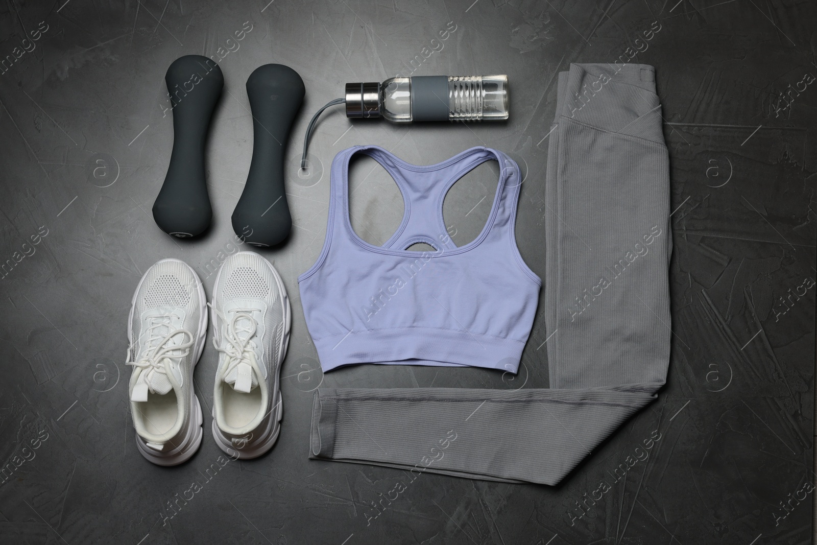Sportswear, sneakers, dumbbells and water bottle on grey background, flat lay Photo of Sportswear, sneakers, dumbbells and water bottle on grey background, flat lay