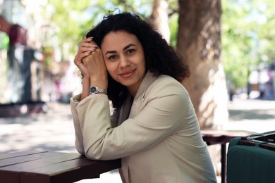 Photo of Portrait of beautiful Latin American woman in outdoor cafe