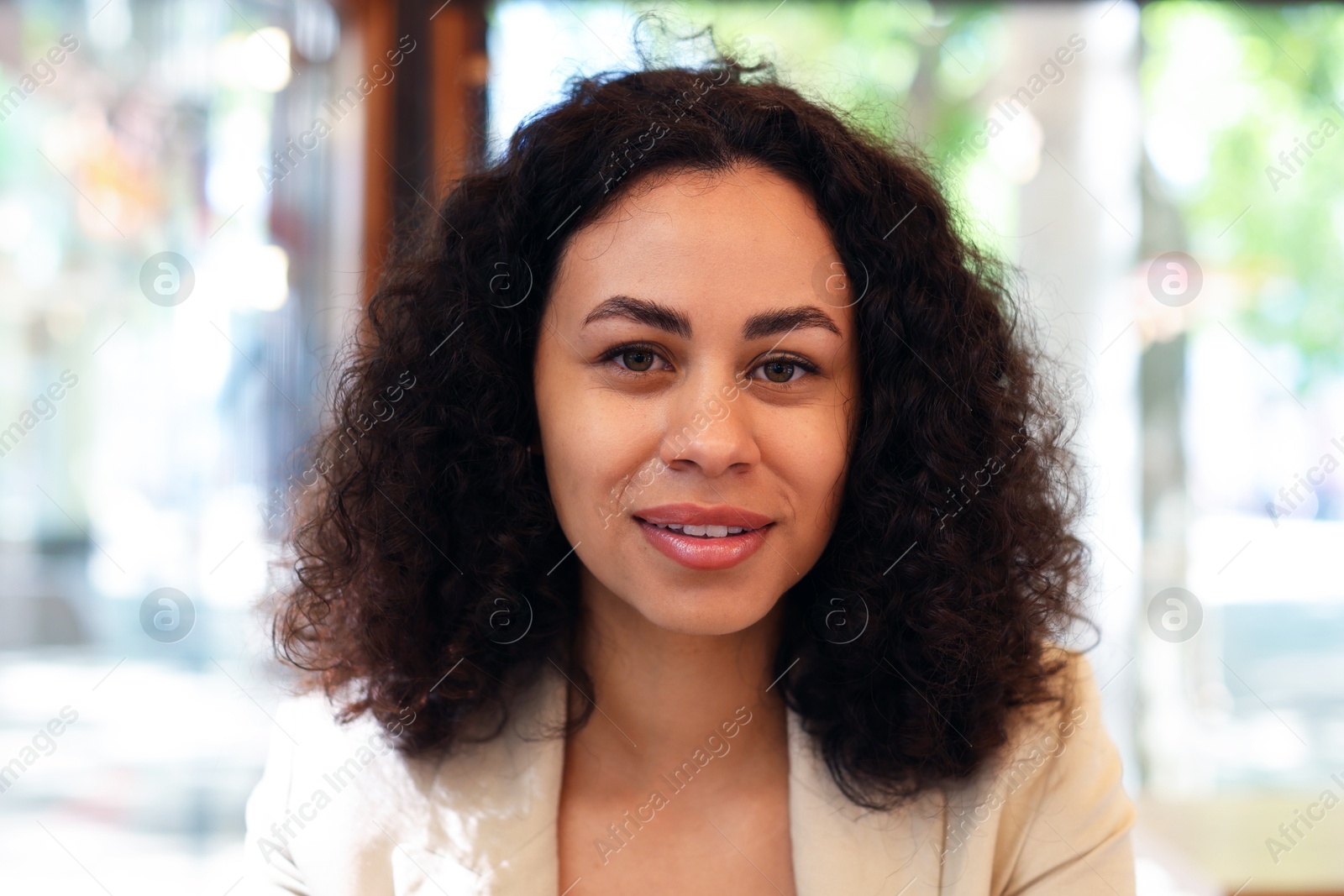 Portrait of smiling Latin American woman in cafe Photo of Portrait of smiling Latin American woman in cafe