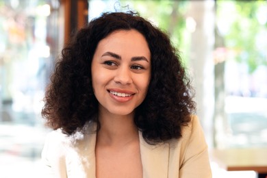 Photo of Portrait of smiling Latin American woman in cafe
