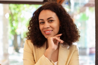 Photo of Portrait of smiling Latin American woman on blurred background