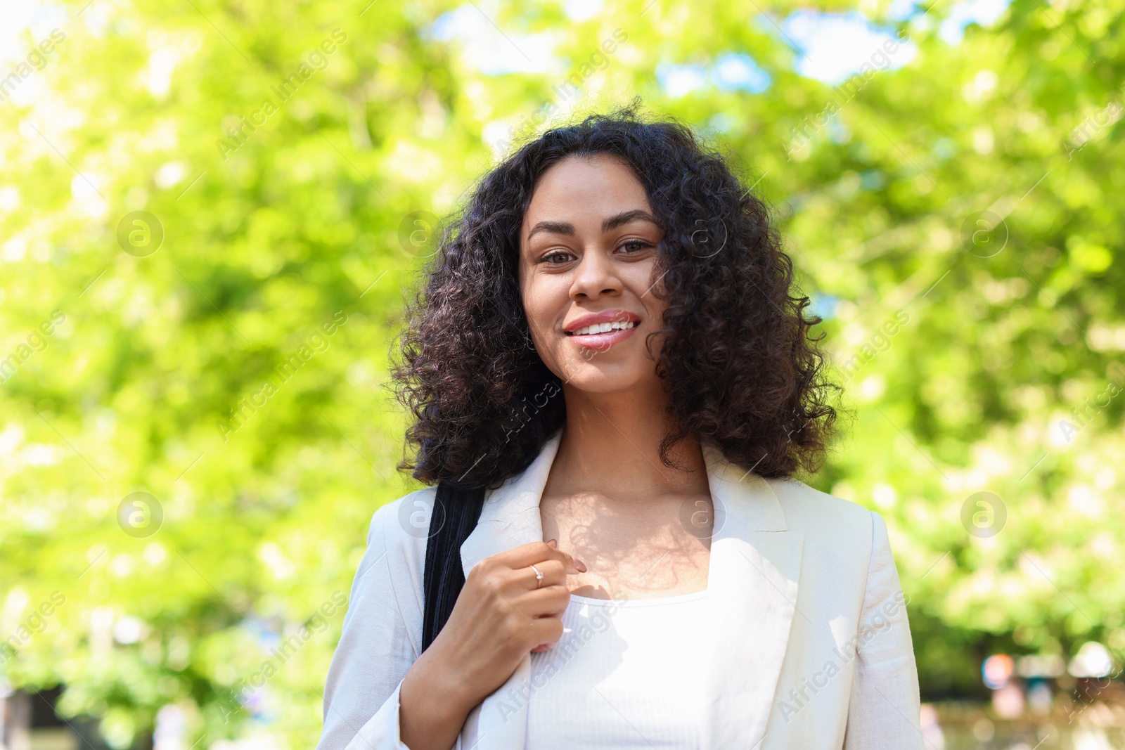 Portrait of smiling Latin American woman outdoors Photo of Portrait of smiling Latin American woman outdoors