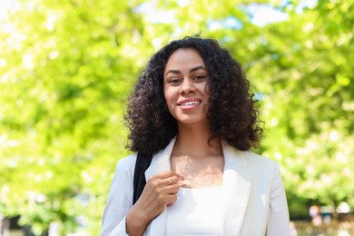 Photo of Portrait of smiling Latin American woman outdoors