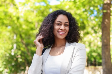 Photo of Portrait of smiling Latin American woman outdoors