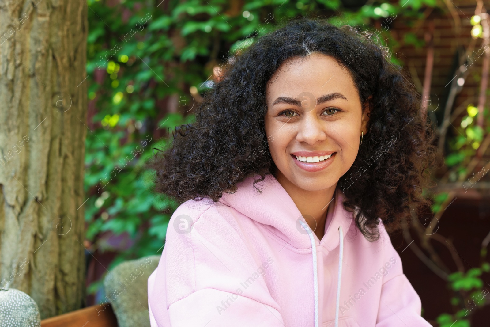 Portrait of smiling Latin American woman outdoors Photo of Portrait of smiling Latin American woman outdoors