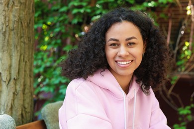 Photo of Portrait of smiling Latin American woman outdoors